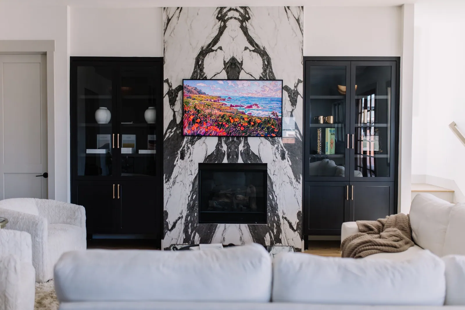 Living room with a floor-to-ceiling marble fireplace